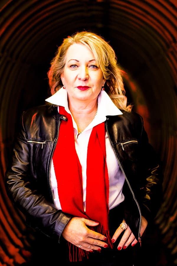 Professional editorial executive portrait in leather jacket and red scarf